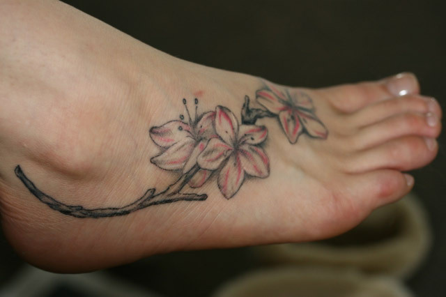 Gracious flower tattoo. Could use a little more detail. flower foot tattoos