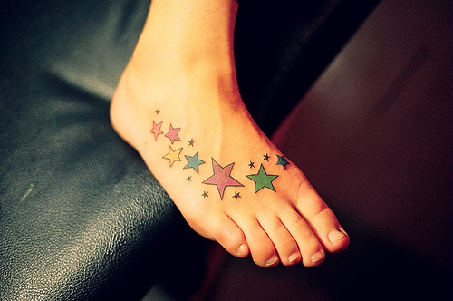 Star Tattoos Behind The Ear. Woman Ear with Star Tattoos