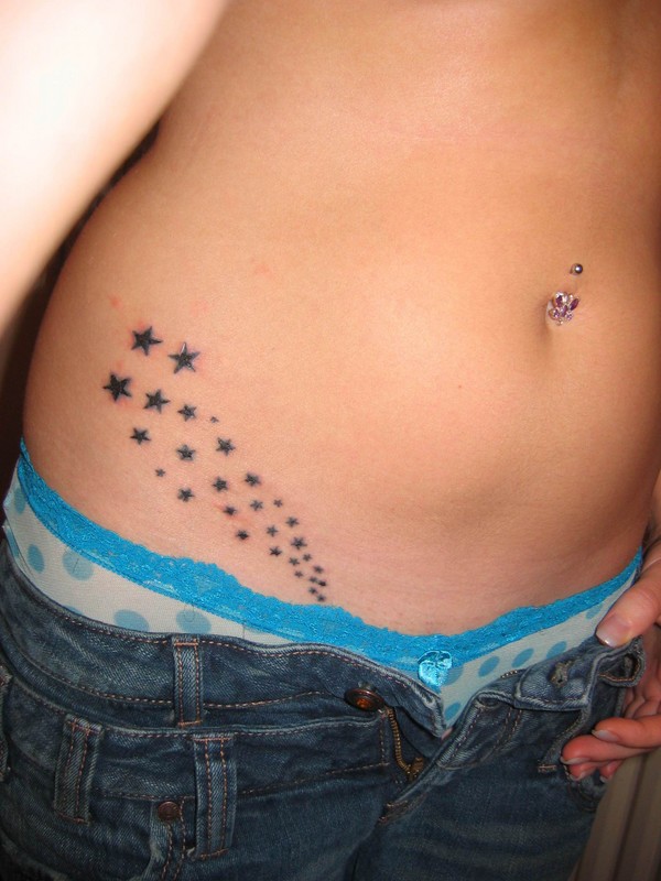 Nice hip tatto integrated iwth a little tribal accent. star hip tattoos